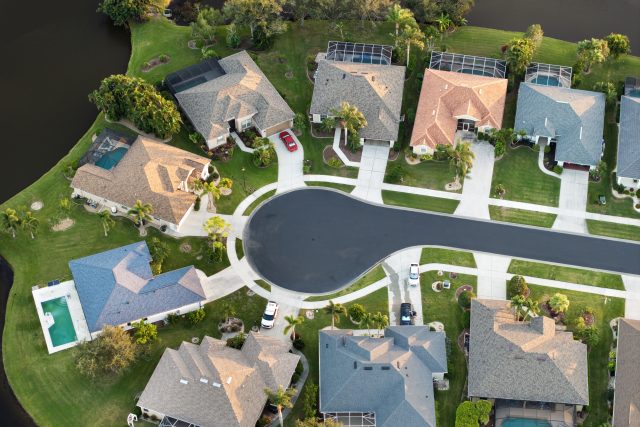 Aerial evening view of spacious family houses in Florida suburban area. Real estate development in American suburbs.